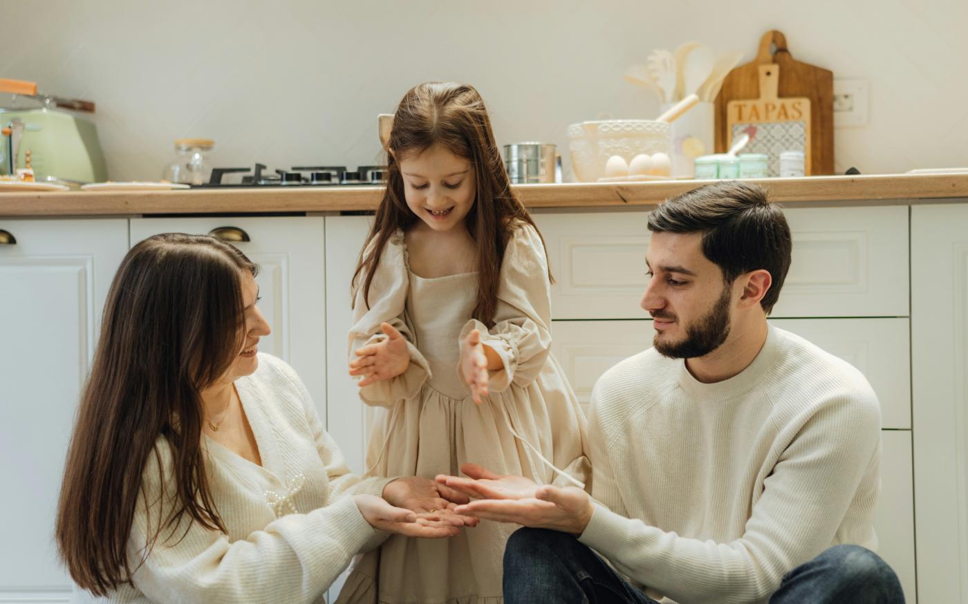 A group of people sitting around in a kitchen by Seljan Salim courtesy of Unsplash.