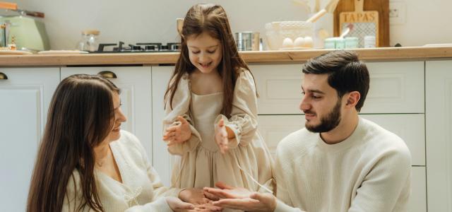 A group of people sitting around in a kitchen by Seljan Salim courtesy of Unsplash.